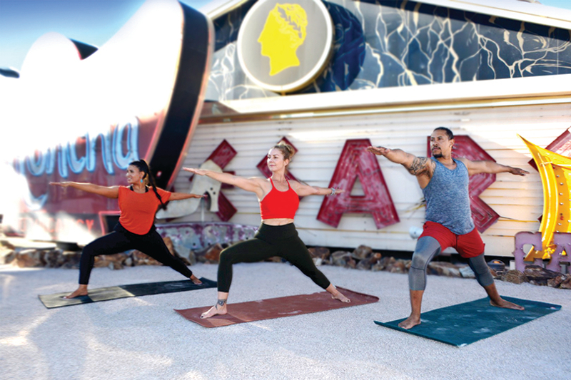 Three people participate in Hot Yoga in the Boneyard