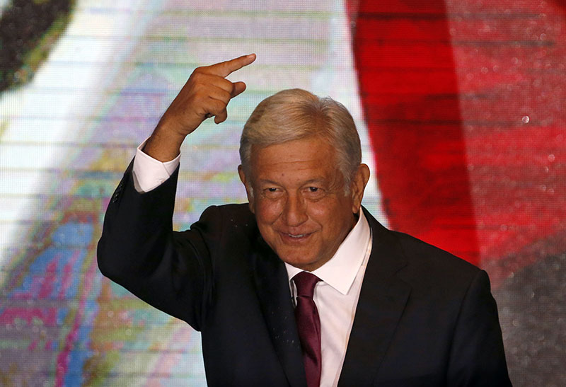 Presidential candidate Andres Manuel Lopez Obrador gestures to supporters as he gives his first victory speech at his campaig