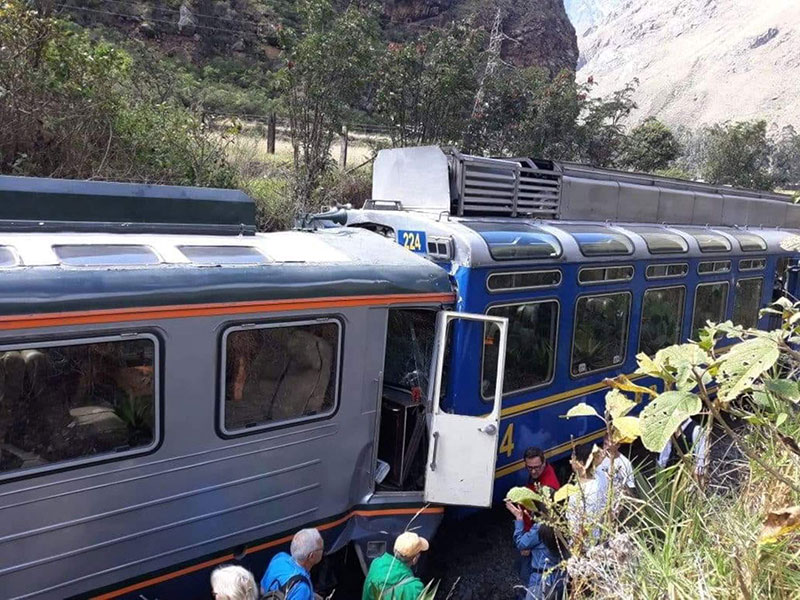 Passengers observe two trains after they collided in Cuzco Peru 