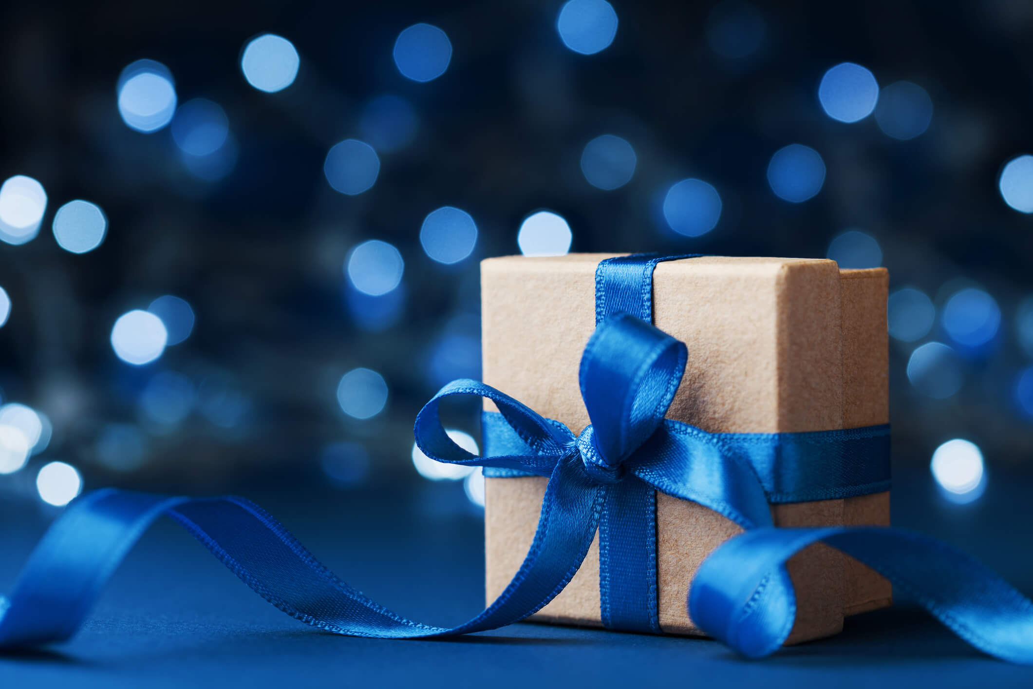 Gift box wrapped with blue ribbon