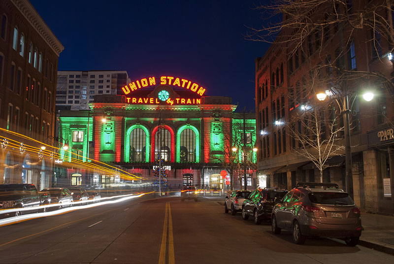 View of Union Station in downtown Denver Colorado taken at night from the middle of a street The train station is lit up f