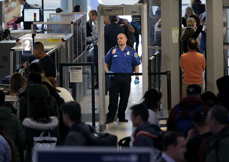 Transportation Security Administration agents help passengers through a security checkpoint at Newark Liberty International A
