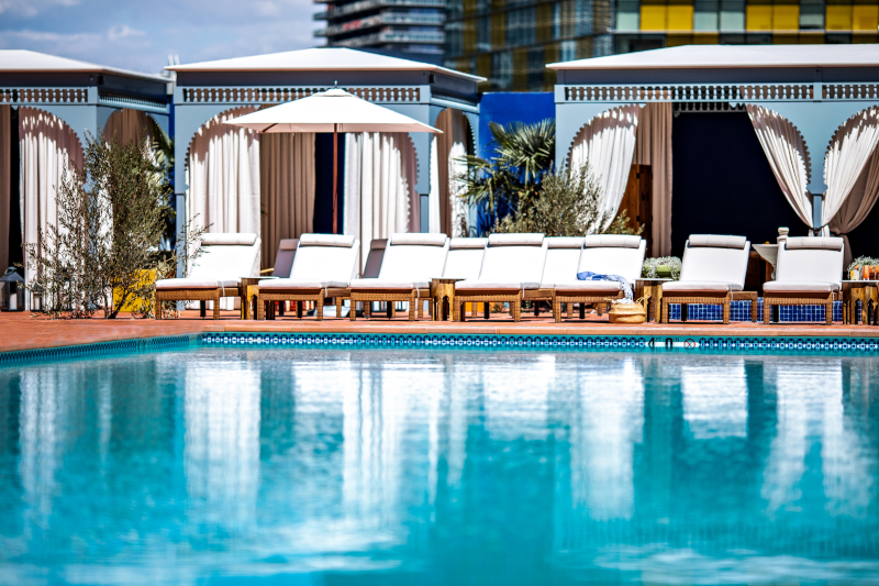The new pool at Nomad Las Vegas with chairs and cabanas in the background