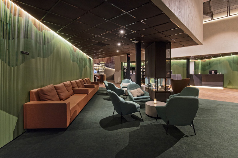 Image of the lobby with couch and green walls 