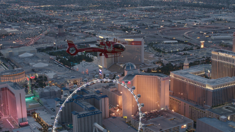 Image of helicopter soaring over Ferris Wheel 