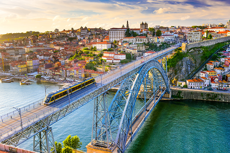  train crosses the Dom Luis I Bridge over the Douro River in Porto Portugal