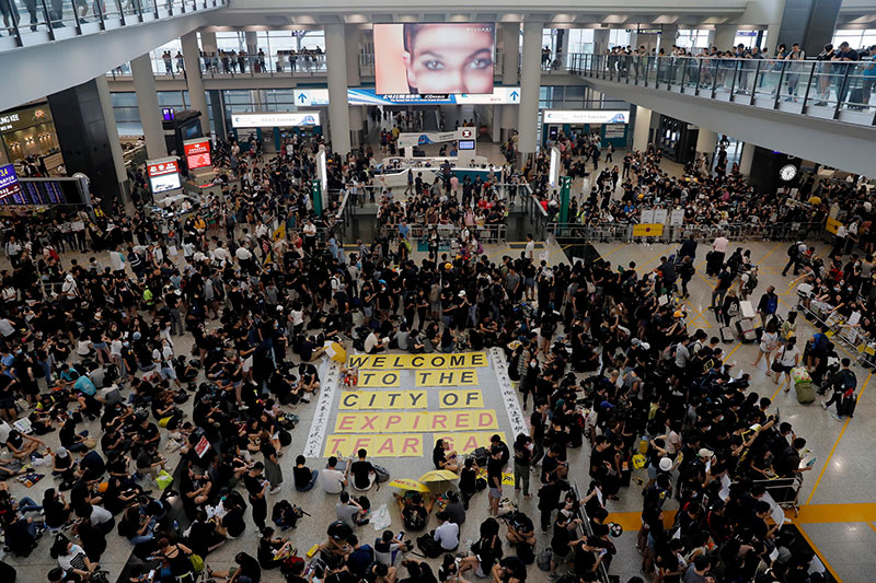 Thousands take part in a sit-in protest at the airport in Hong Kong