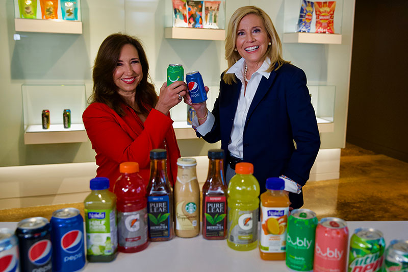 President of Carnival Cruise Line Christine Duffy L and President of PepsiCo Global Foodservice Anne Fink R toast to thei