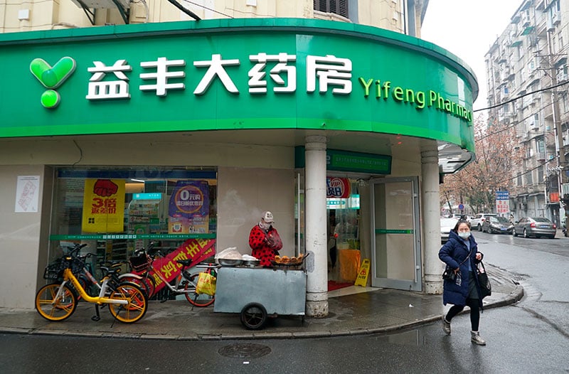 A customer walks out of a Yifeng Pharmacy in Wuhan China