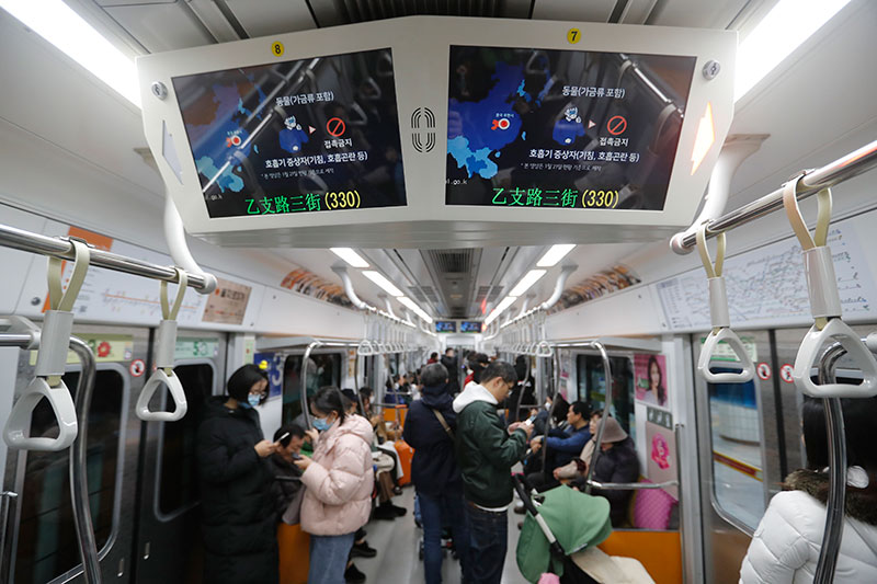Screens warning about a new coronavirus are seen in a subway train in Seoul South Korea