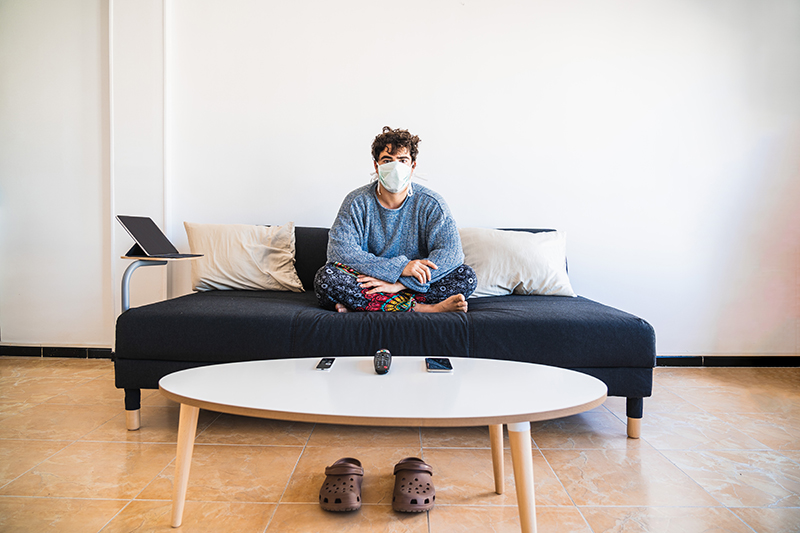 Man with mask at home quarantining