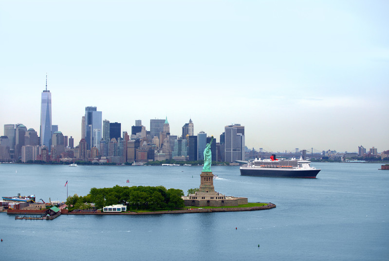 Queen Mary 2 sails with New York City skyline in background
