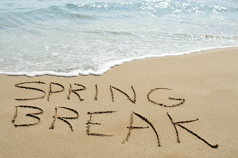 Spring Break written in the sand