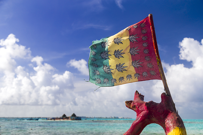 Cannabis tourism flag on beach