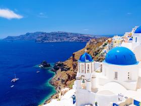 White architecture and churches with blue domes, Oia, Santorini, Greece