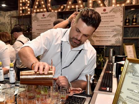 Bartender pouring cocktails at the Bacardi booth