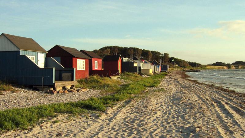 Tiny huts catch the light of the sunset on Ærø