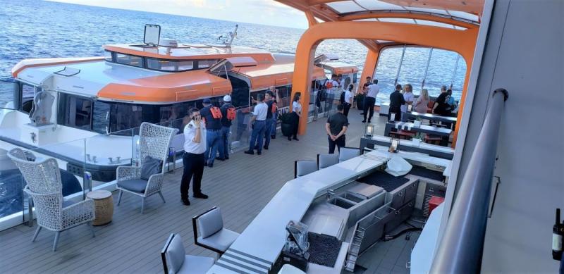 Guests use the Magic Carpet to board tenders. This embarkation area for the launches, though, has some special perks such as a bar and various seating areas.  and seating areas 