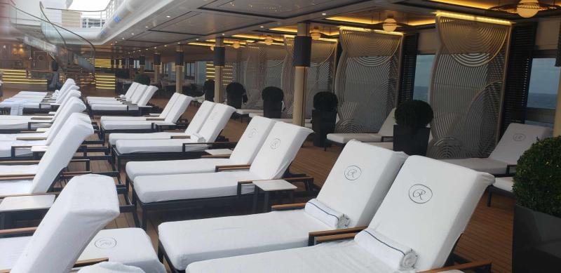 The pool deck of Seven Seas Grandeur has many comfortable lounge chairs.