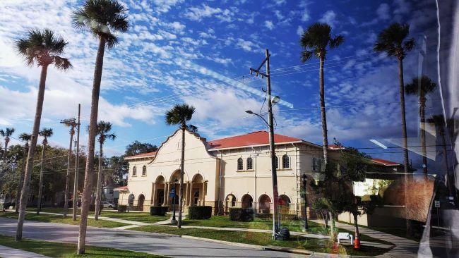 Photo taken from the Green Cove Springs motorcoach tour by ACL. City Hall in Green Cove Springs, FL, surrounded by soaring palm trees.