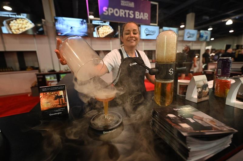 A woman displays her product at BRE2021 Sports Bar