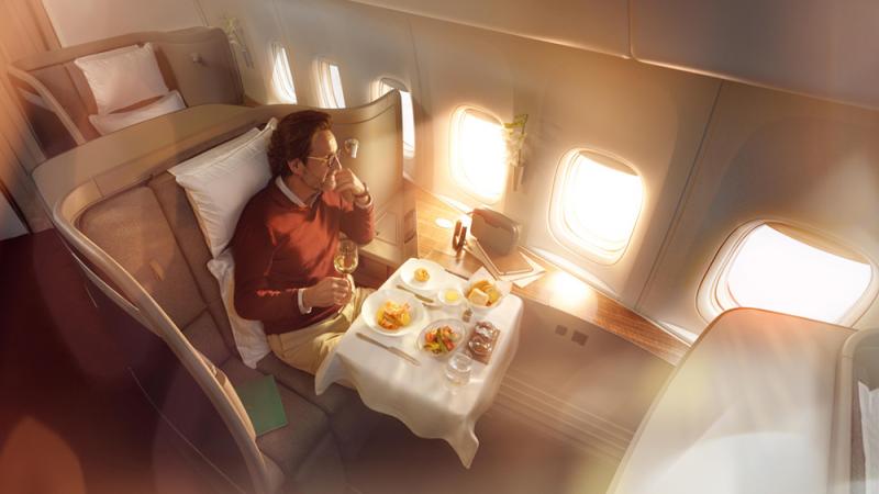 A man dining in Cathay Pacific's First Class seat
