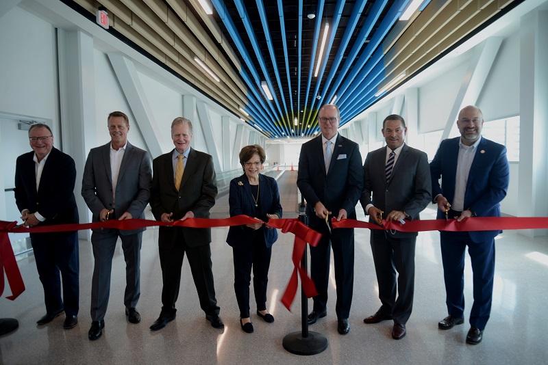 Officials in South Florida celebrate the opening of Port Everglades Heron Garage and elevated bridge with moving walkways.