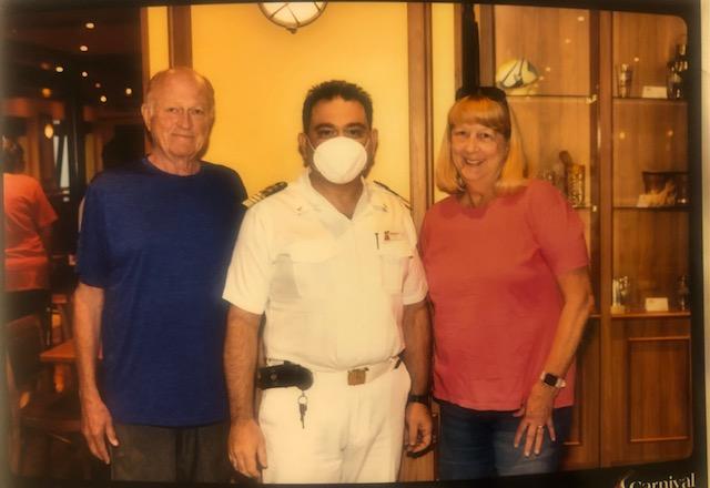 James ("Jim") Kretschmar, at left, and his new wife, Pris Phillips, associate, Dream Vacations, are shown with Captain Lorenzo Calogero on the Carnival Sunshine a few days ago. 