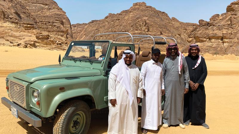 Saudi drivers at AlUla’s Desert X exhibition  pose with a vintage 4x4.