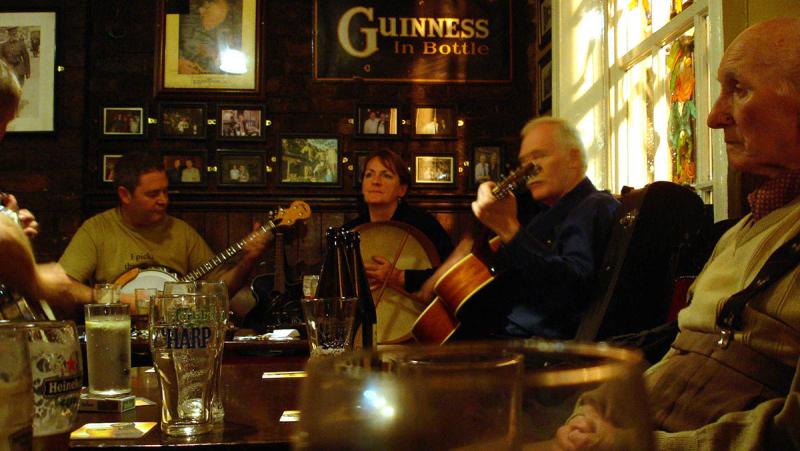 A group of musicians play in an Irish pub