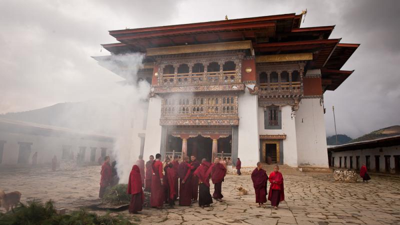 Monks burning cypress leaves as incense in front of Gangtey Monastery.jpg