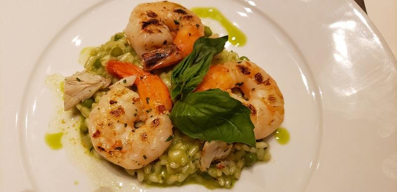 Grilled jumbo prawns with green asparagus and lump crab meat risotto, basil infusion.