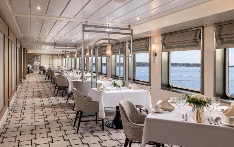 This is one of two singular aisle dining room table areas, located on either side of the galley (not visible to guests). The two aisles lead to a much wider part of the dining room aft.