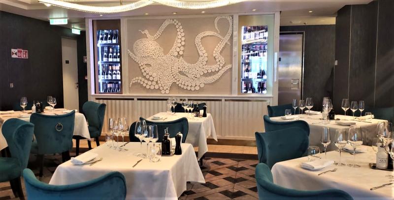La Terrazino, the main portion of this specialty Italian dining area, on Silver Endeavour; other seating is also outside along a corridor near the ship's windows. 