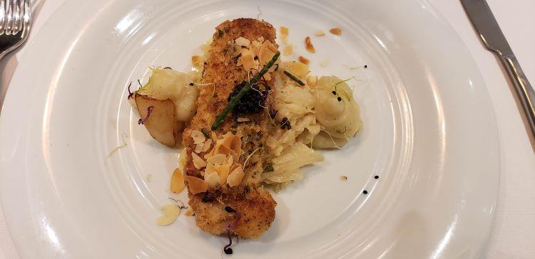 Dover Sole Amandine, a specialty dish by Chef Rudi Scholdis, served on Atlas Ocean Voyages' World Traveller.