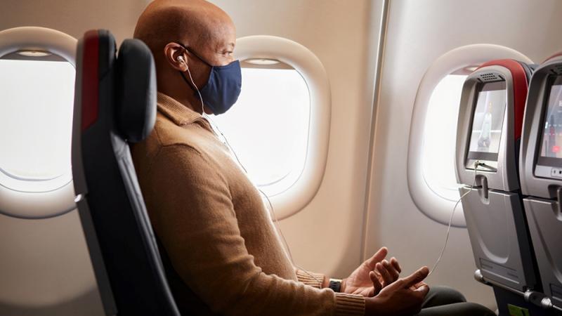 Man meditating on airplane