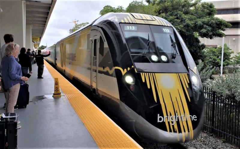 A Brightline train arrives at the Fort Lauderdale station in South Florida. Passengers prepare to board. 