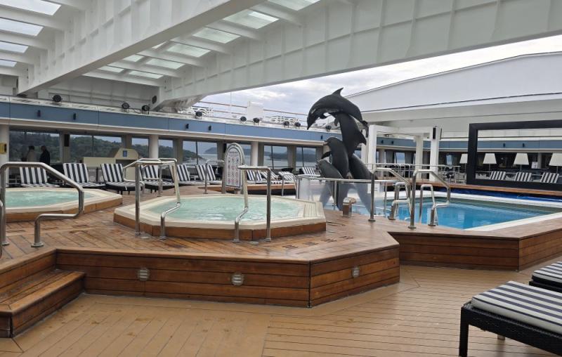 This original dolphins leaping statue is a remnant from the former Holland America Ryndam. Today it still graces the magradome pool area of Celestyal Journey.