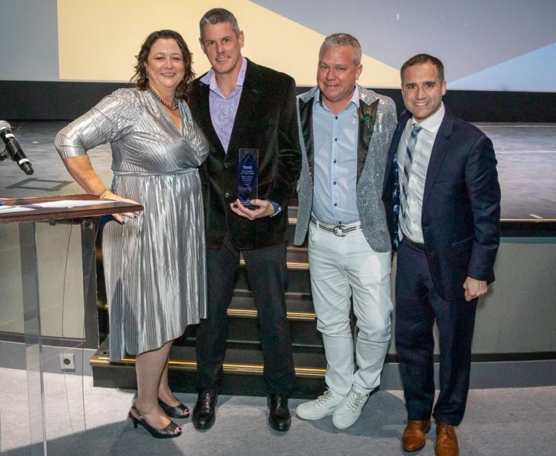 Photo of Franchise of the Year Award winners - Trapper Martin and Shane Smartt of Dream Vacations, Orlando, FL; left to right are Debbie Fiorino, COO for the Dream Vacations and CruiseOne brands, then Smartt, Martin and Brennan Quesnele, VP of strategic and national accounts for Norwegian Cruise Line.