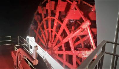 The red paddlewheel of American Queen propels the ship along the Mississippi River. 