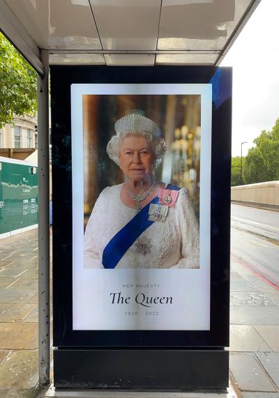 A London bus stop with Queen Elizabeth's image