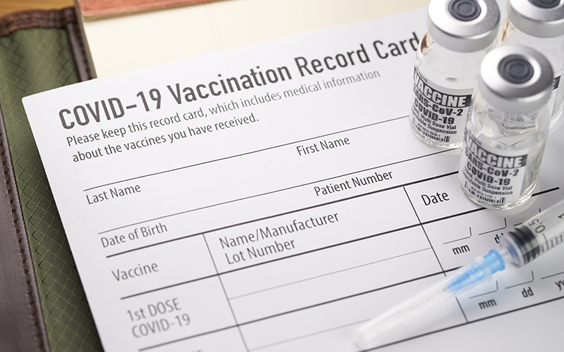 COVID-19 vaccine card and vaccine vials