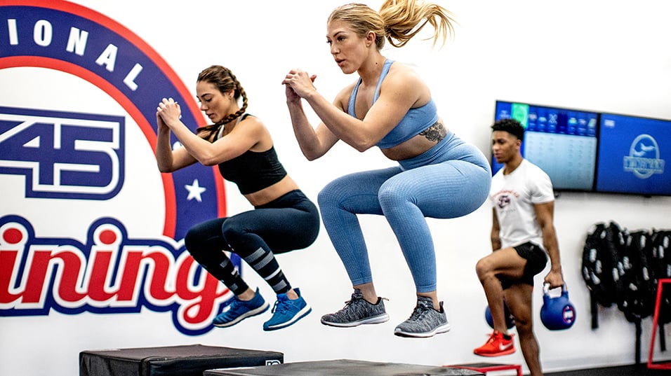 Two women jumping at an F45 Training studio in Hilton hotel in Austin Texas