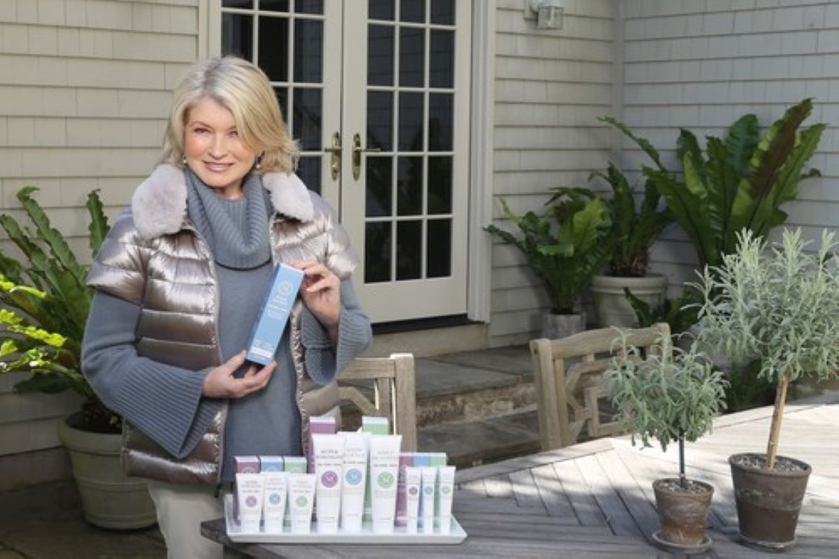Martha Stewart standing next to her new line of CBD wellness topicals