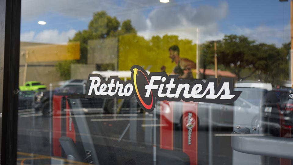 Reflection on window of a Retro Fitness club
