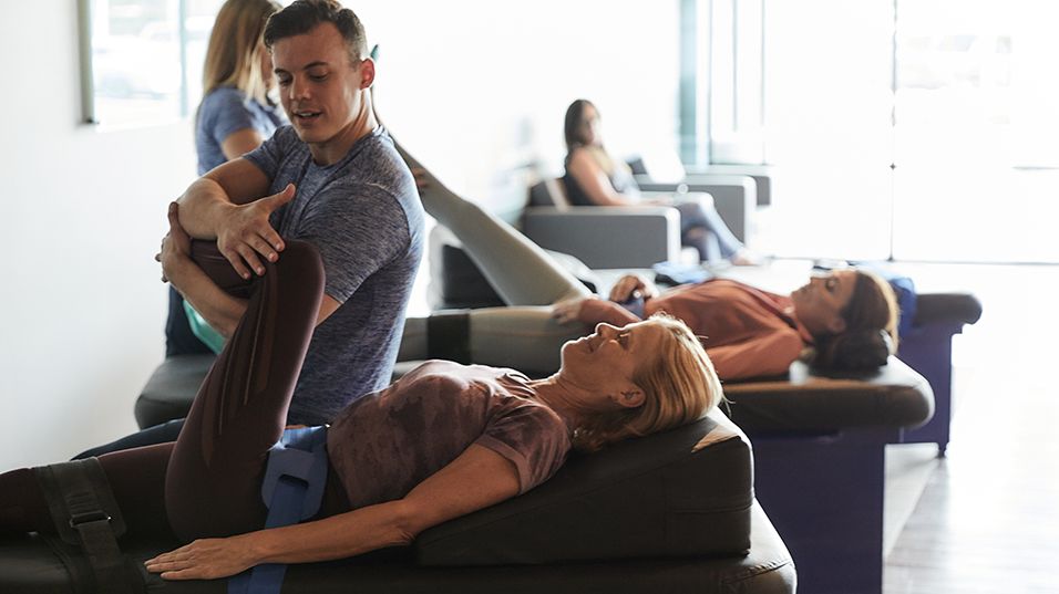 Woman being stretched out at Stretch Zone facility