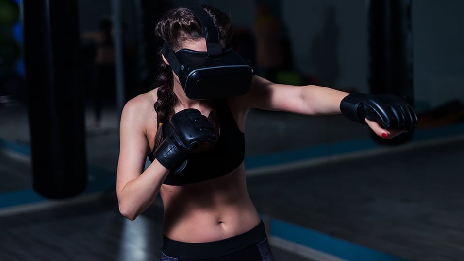 Woman using virtual reality to box