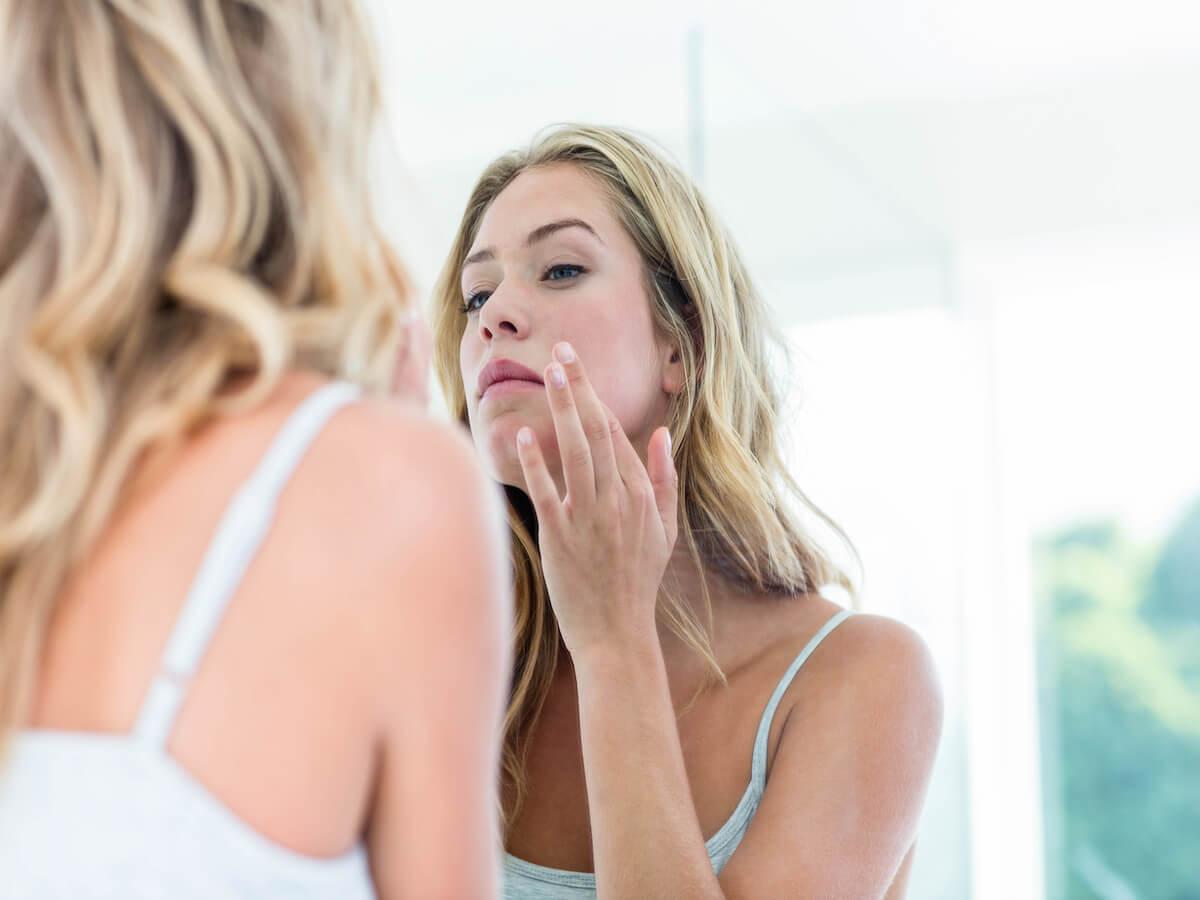  Image of woman looking in the mirror  Photo credit iStock  Getty Images Plus  Wavebreakmedia