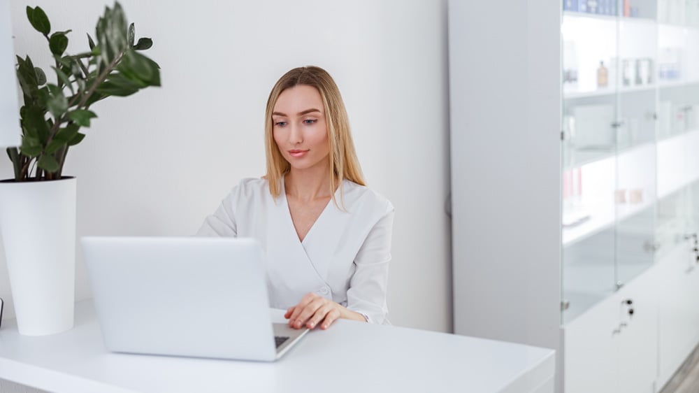 Spa employee working on laptop