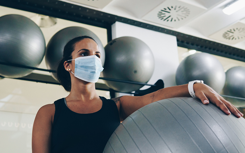 Masked woman in gym
